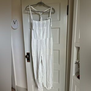 Beautiful romper with details like tied straps and slightly metallic striping.